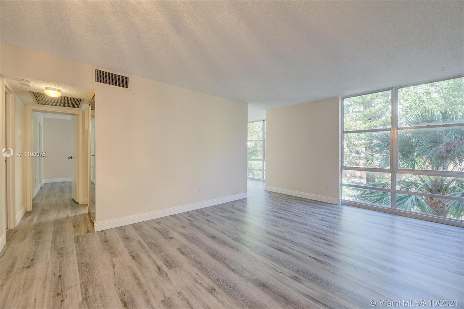 200 172nd Street, Unit 317 Sunny Isles Beach, FL 33160 - Photo 6 of 27 wooden floor in an empty room with a window
