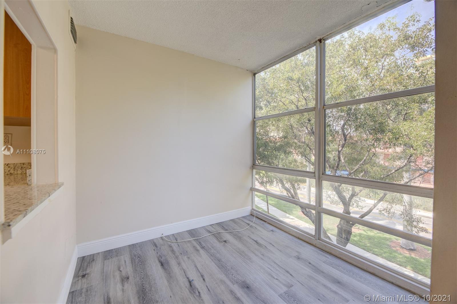 200 172nd Street, Unit 317 Sunny Isles Beach, FL 33160 - Photo 7 of 27 a view of empty room with wooden floor and fan
