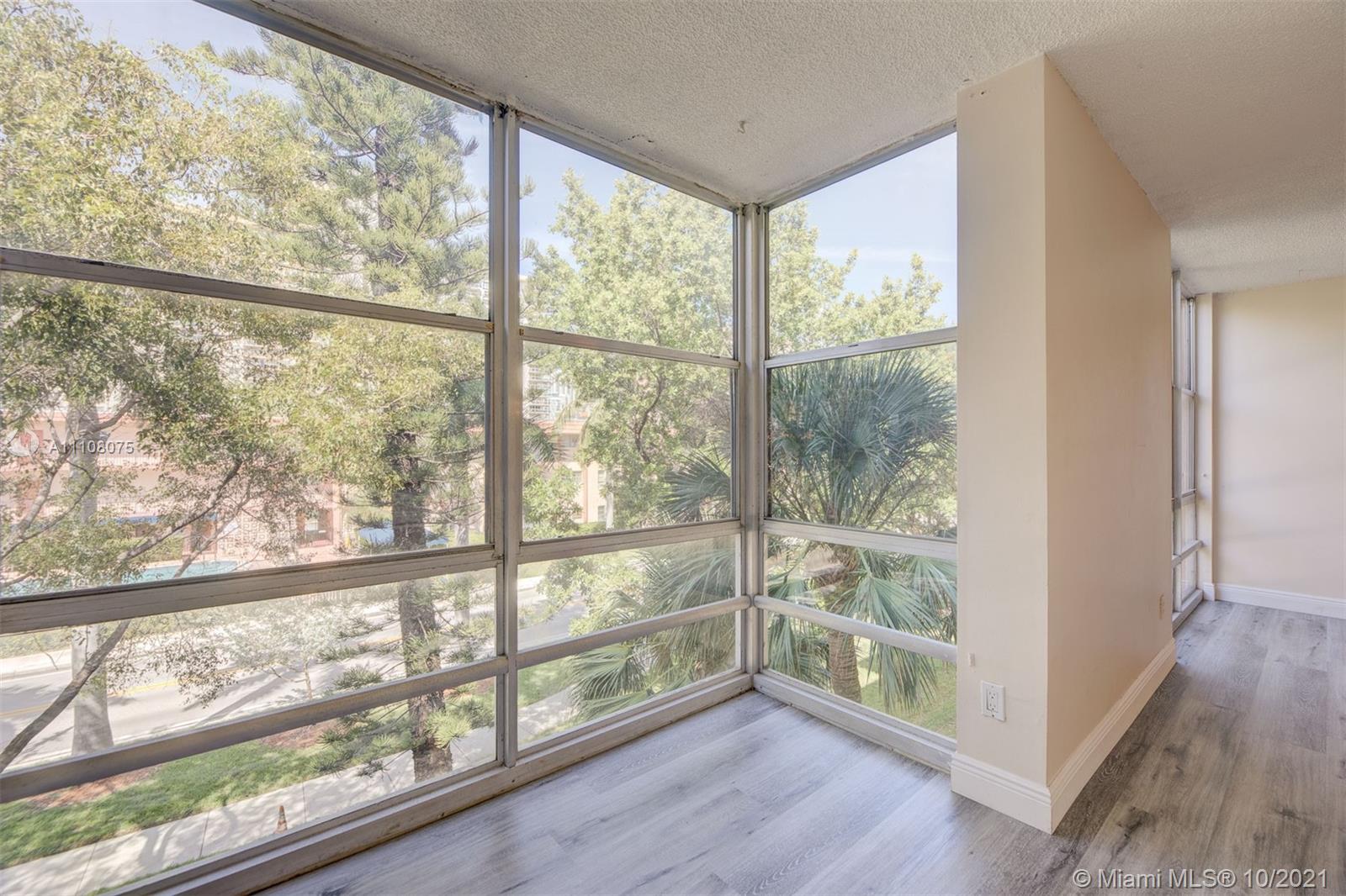 200 172nd Street, Unit 317 Sunny Isles Beach, FL 33160 - Photo 8 of 27 a view of a room with wooden floor and doors