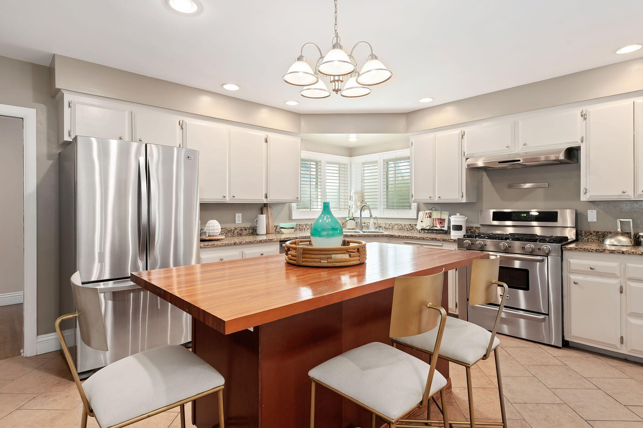 42 Northridge Road Santa Barbara, CA 93105 - Photo 9 of 22 a kitchen with granite countertop a table chairs stove and cabinets