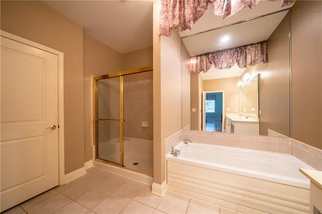 a bathroom with a shower and a tub