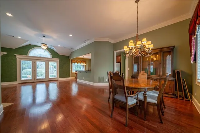 a view of a dining room with furniture window and wooden floor