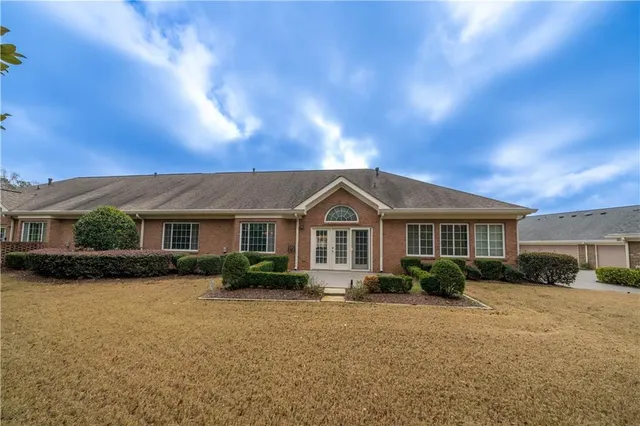 a view of house with a yard