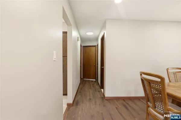 a view of a hallway with wooden floor