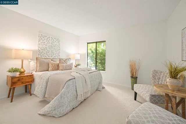 a bedroom with a bed and a potted plant