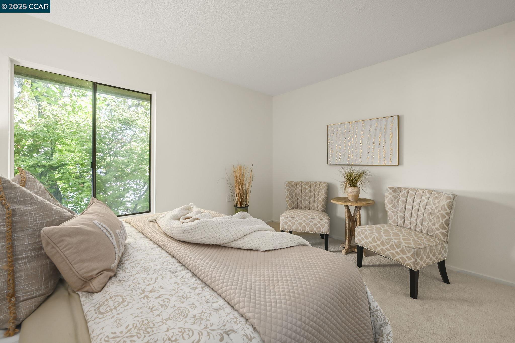 1324 Singingwood Court, Unit 3 Walnut Creek, CA 94595 - Photo 18 of 36 a bedroom with a bed and a large window