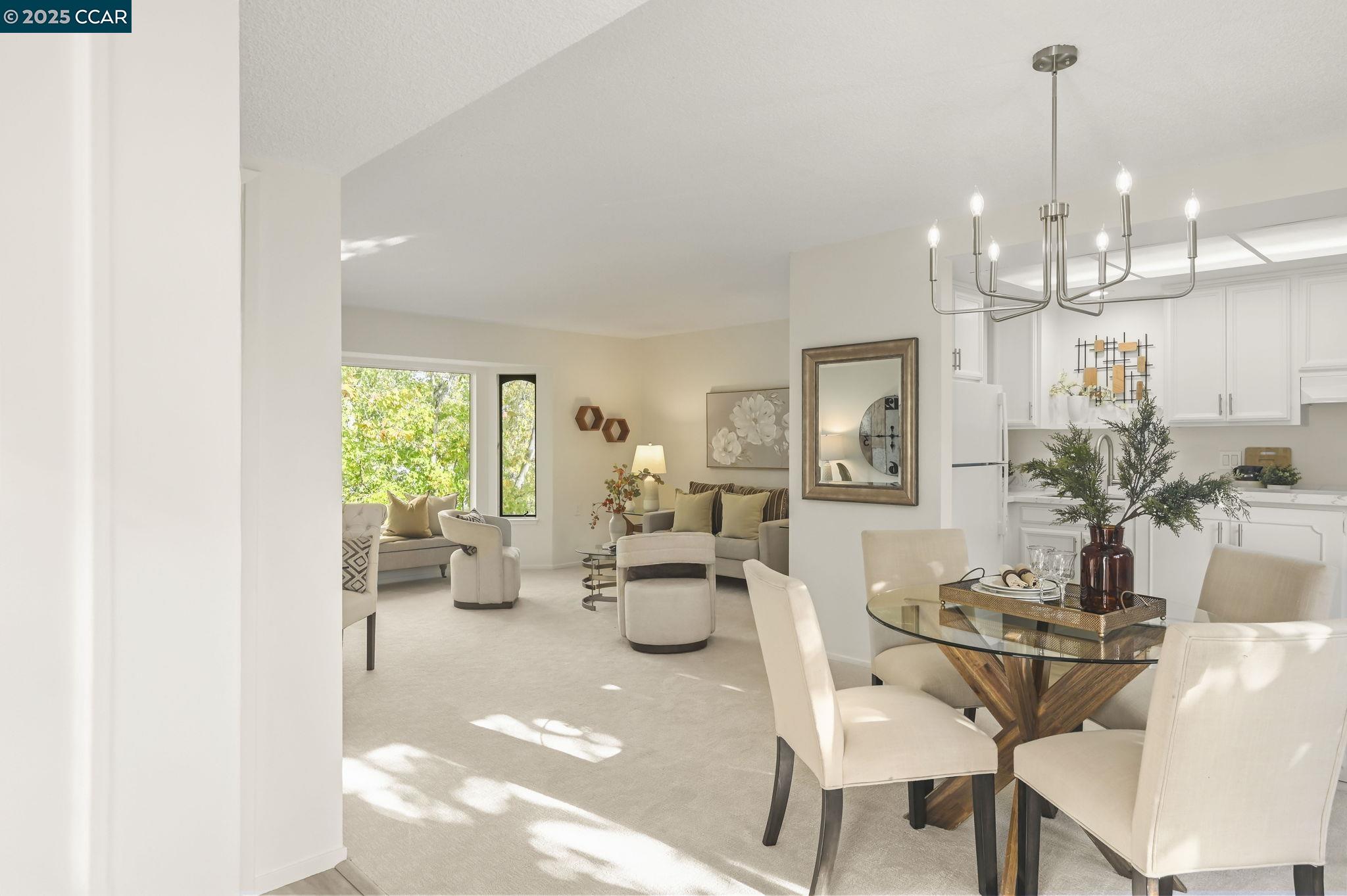 1324 Singingwood Court, Unit 3 Walnut Creek, CA 94595 - Photo 4 of 36 a view of a dining room with furniture and chandelier
