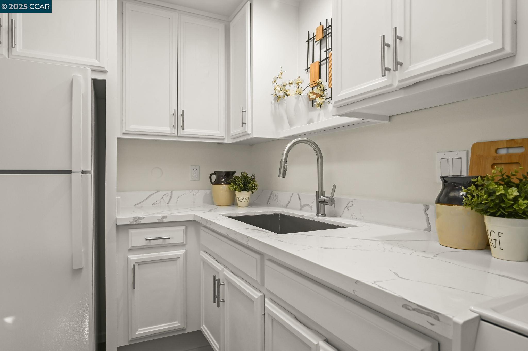 1324 Singingwood Court, Unit 3 Walnut Creek, CA 94595 - Photo 9 of 36 a kitchen with white cabinets and appliances