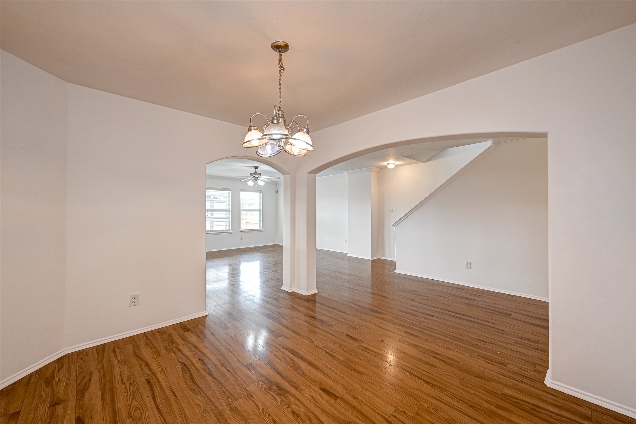 6906 Anson Point Lane Houston, TX 77040 - Photo 6 of 31 a view of an empty room with wooden floor and a chandelier