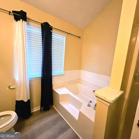 a bathroom with a bathtub sink and toilet