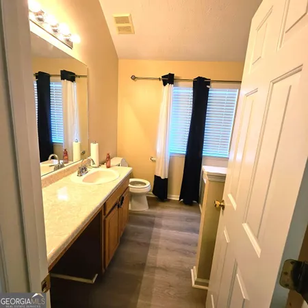 a bathroom with sink a mirror a vanity and a shower