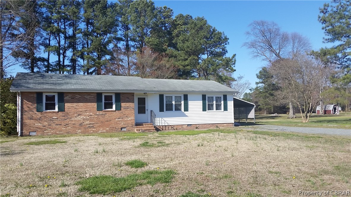 292 Evans Road Mathews, VA 23109 - Photo 1 of 37 a front view of a house with a yard
