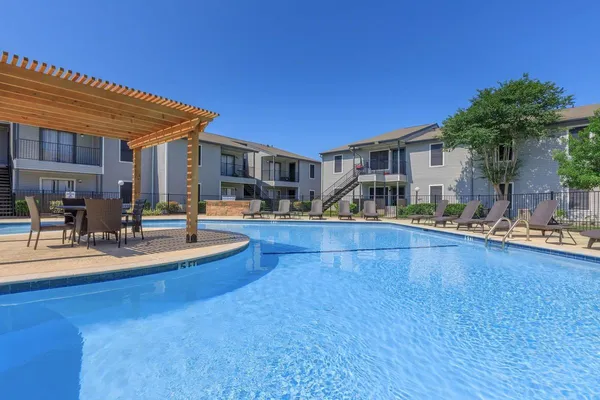 a view of a house with swimming pool and sitting area