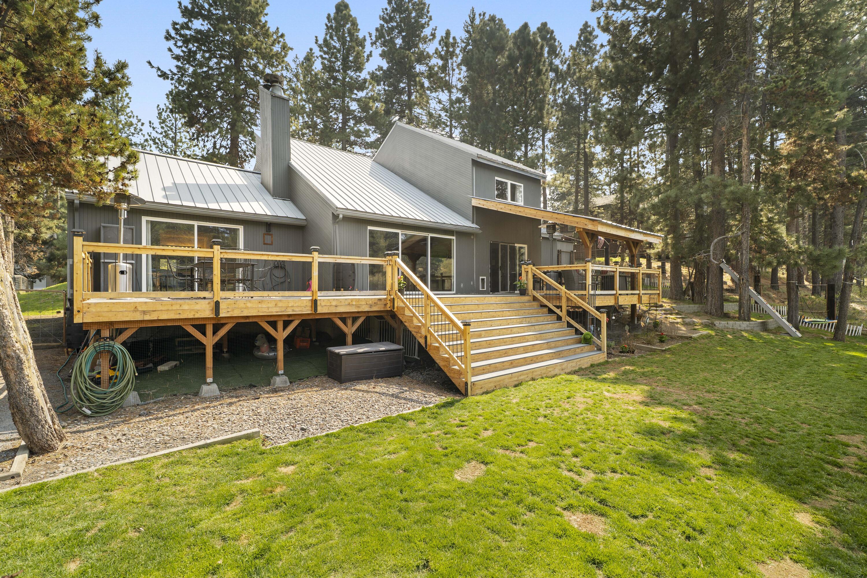 17062 Milky Way Bend, OR 97707 - Photo 24 of 39 Two-tier deck system cascades down the chalet's rear elevation