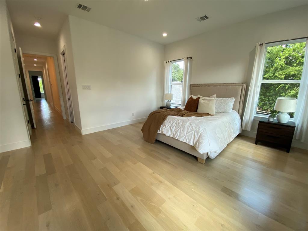 807 South Glasgow Drive Dallas, TX 75223 - Photo 12 of 25 a bedroom with a bed and a view of living room