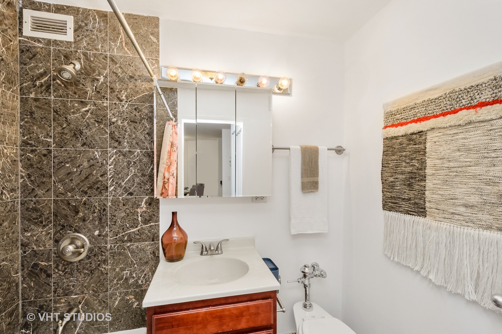 222 East Pearson Street, Unit 707 Chicago, IL 60611 - Photo 13 of 13 a bathroom with a sink and a mirror