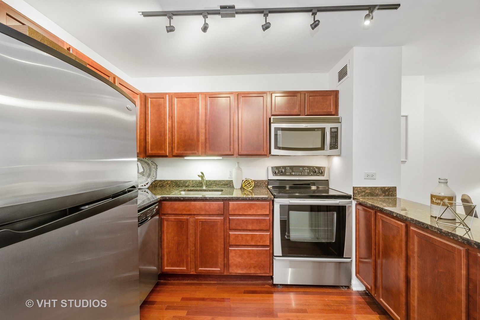 222 East Pearson Street, Unit 707 Chicago, IL 60611 - Photo 8 of 13 a kitchen with a sink stove and microwave