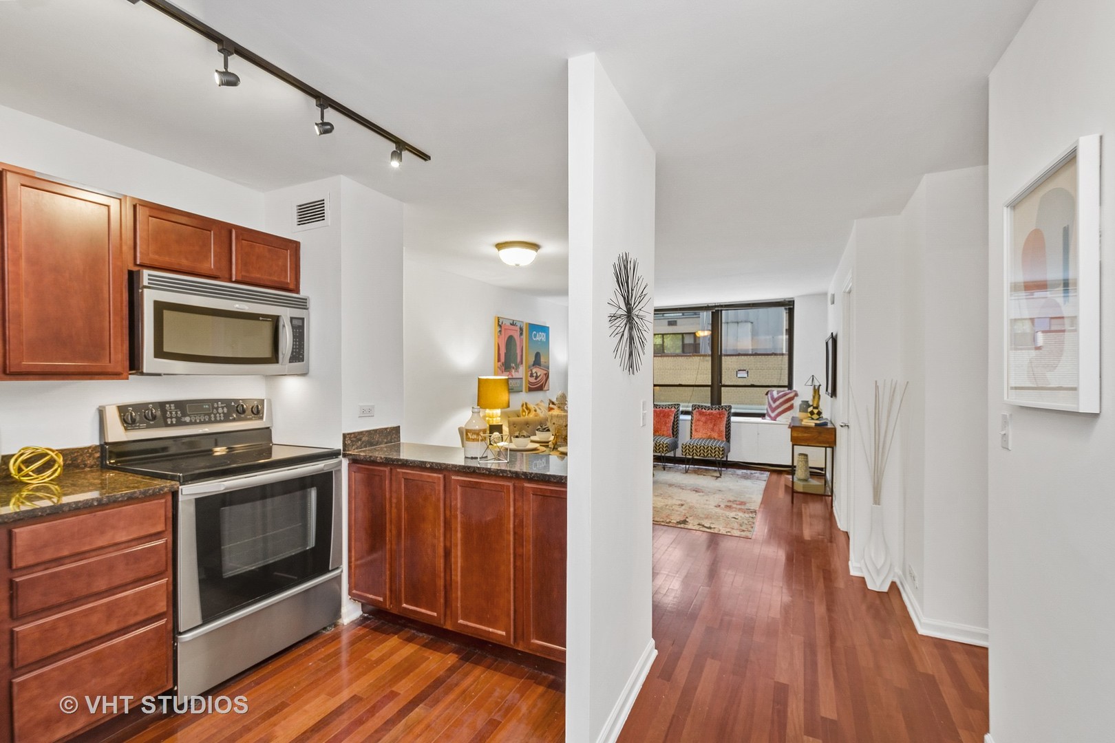 222 East Pearson Street, Unit 707 Chicago, IL 60611 - Photo 9 of 13 a kitchen with stainless steel appliances a stove top oven and refrigerator