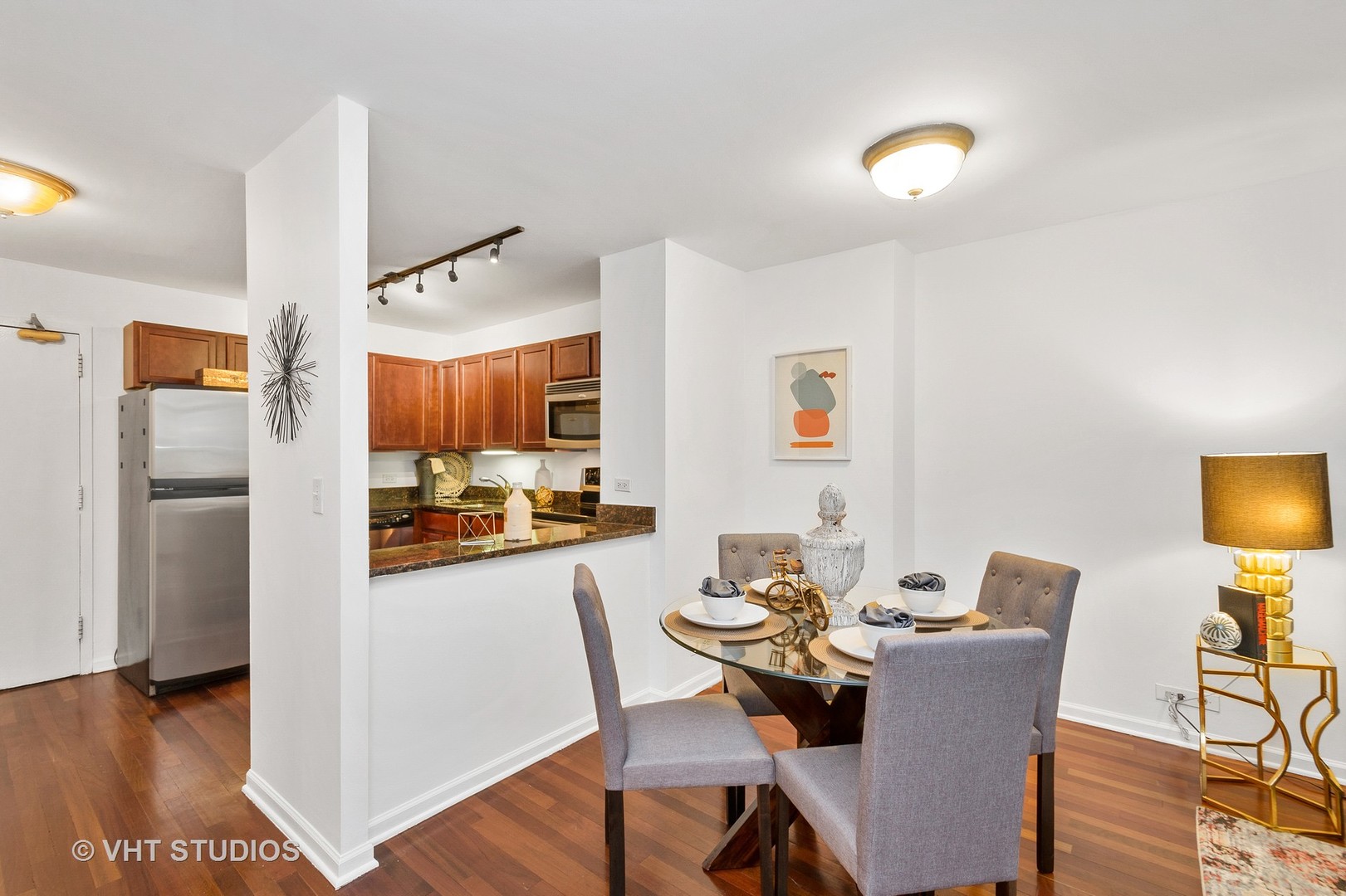222 East Pearson Street, Unit 707 Chicago, IL 60611 - Photo 10 of 13 a dining room with furniture and wooden floor