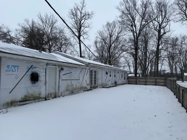 a view of a house with a snow in yard