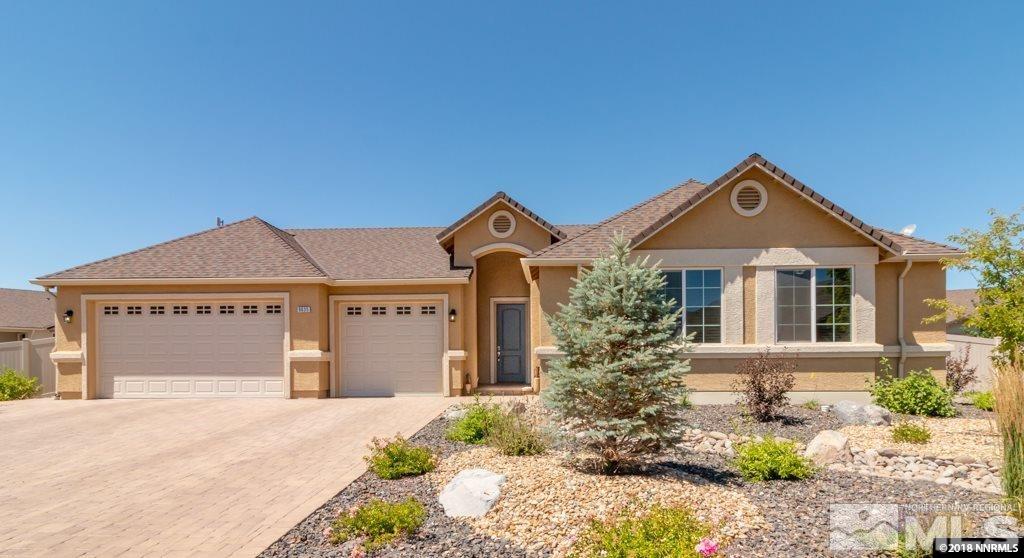 9635 Caitlin Court Reno, NV 89521 - Photo 1 of 23 a front view of a house with a yard and garage