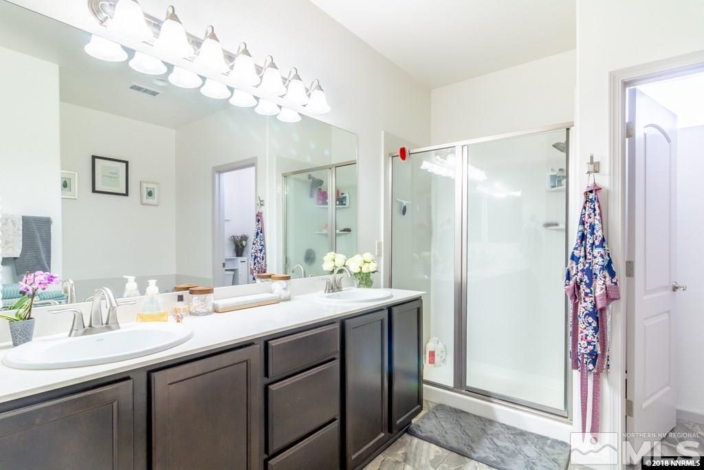 9635 Caitlin Court Reno, NV 89521 - Photo 12 of 23 a bathroom with a sink vanity granite shower and a mirror