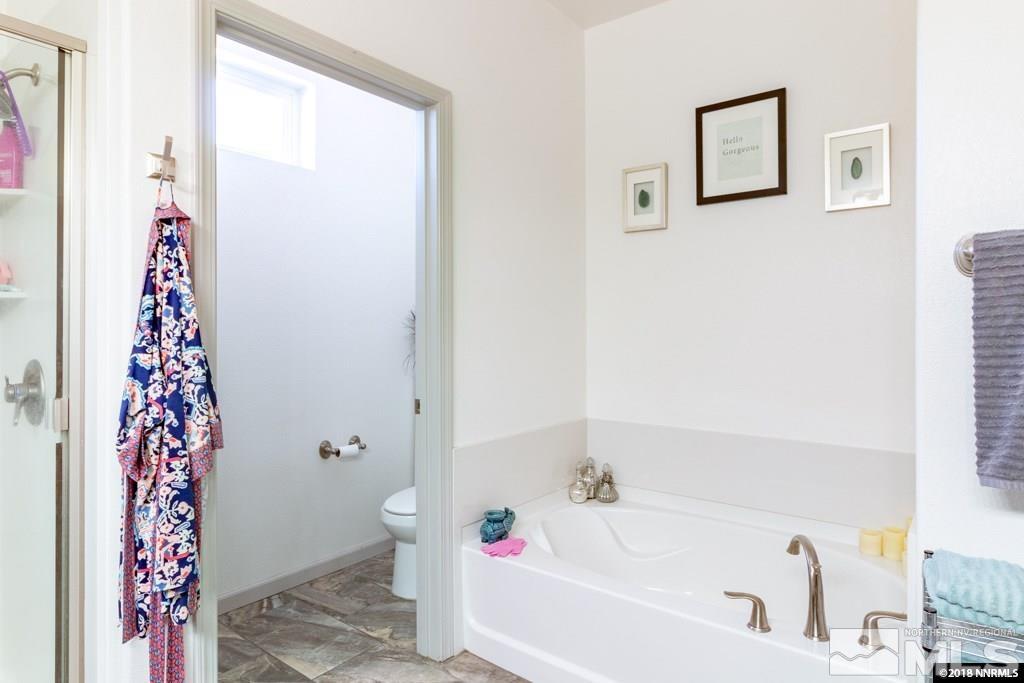 9635 Caitlin Court Reno, NV 89521 - Photo 13 of 23 a bathroom with a bathtub and a shower