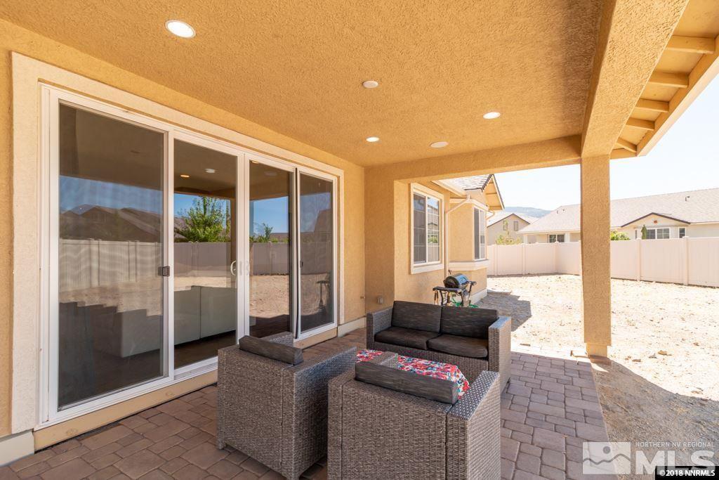 9635 Caitlin Court Reno, NV 89521 - Photo 21 of 23 a living room with furniture and a floor to ceiling window