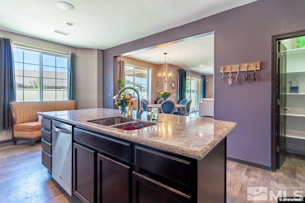 9635 Caitlin Court Reno, NV 89521 - Photo 9 of 23 a kitchen with a stove a sink and a refrigerator