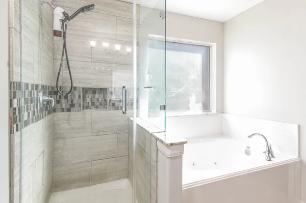 a bathroom with a bathtub and shower