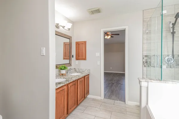 a bathroom with a granite countertop sink and a mirror