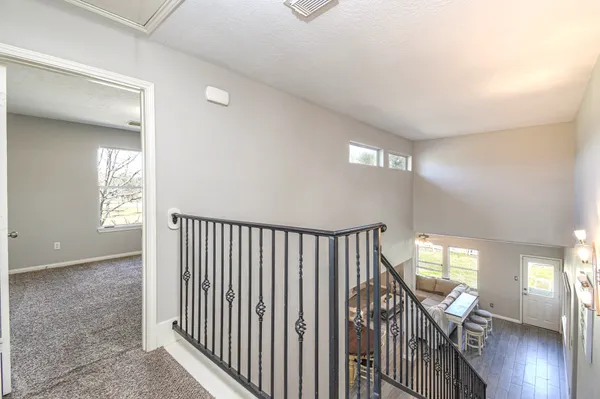 a view of a hallway with wooden floor and stairs