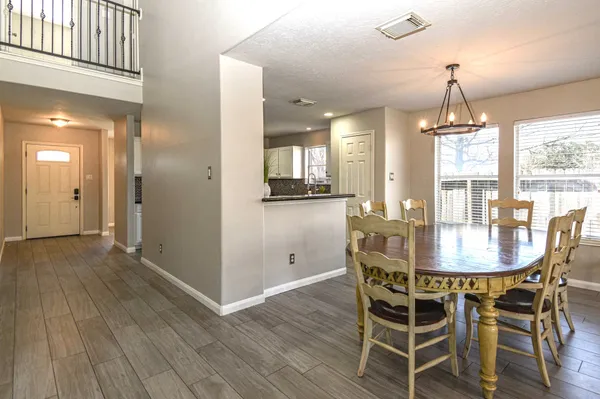 a dining room with furniture window and wooden floor