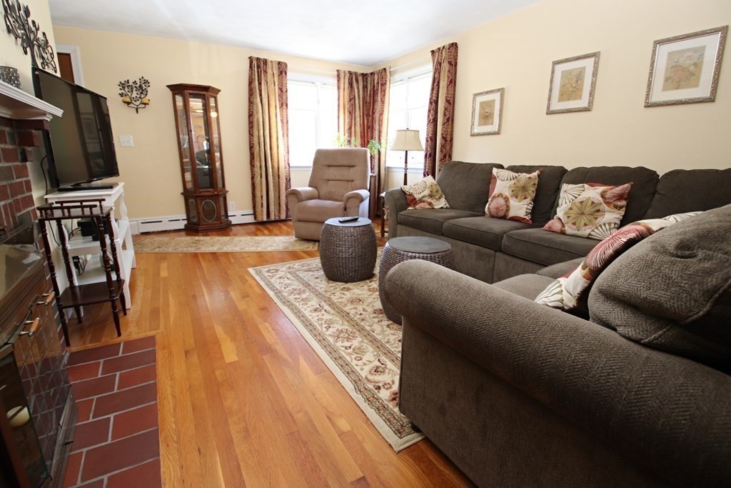 34 Adams Avenue Saugus, MA 01906 - Photo 12 of 42 a living room with furniture a flat screen tv and a window