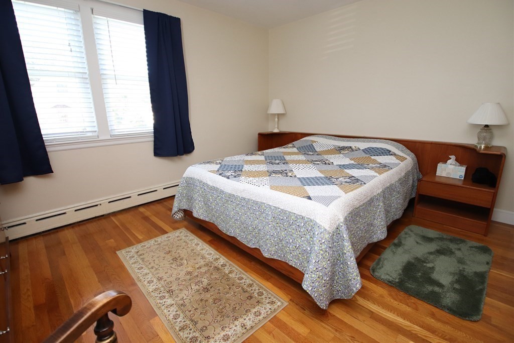 34 Adams Avenue Saugus, MA 01906 - Photo 17 of 42 a living room with a bed and a dresser