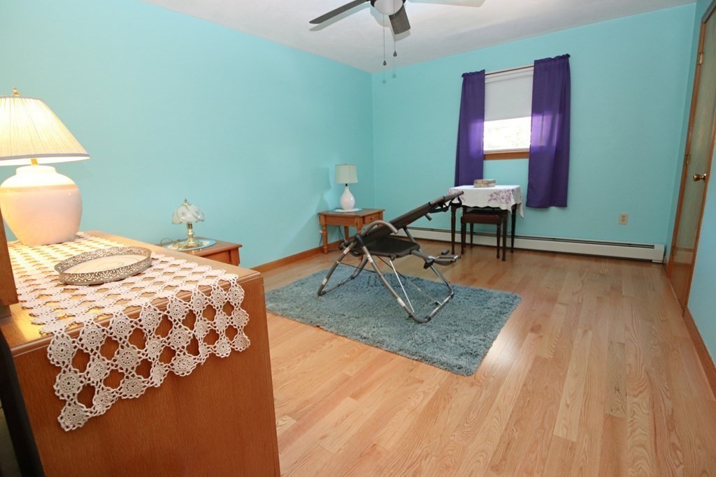 34 Adams Avenue Saugus, MA 01906 - Photo 25 of 42 a bedroom with a bed and a lamp on dresser
