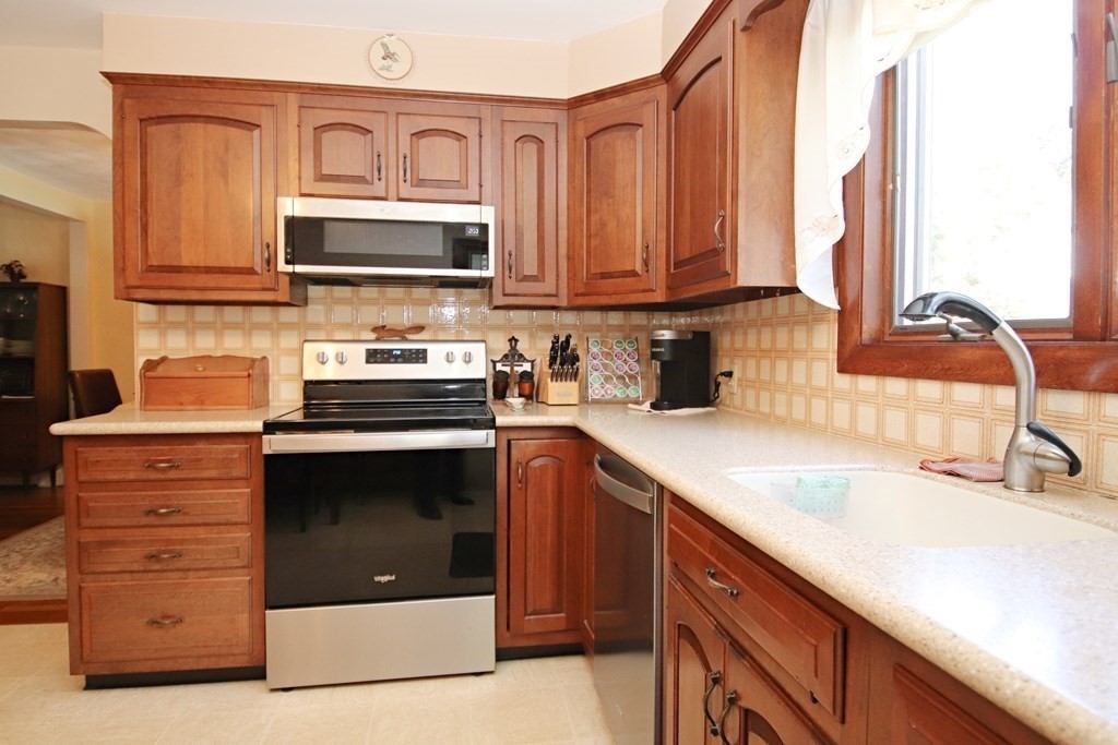 34 Adams Avenue Saugus, MA 01906 - Photo 5 of 42 a kitchen with stainless steel appliances granite countertop a sink stove and microwave
