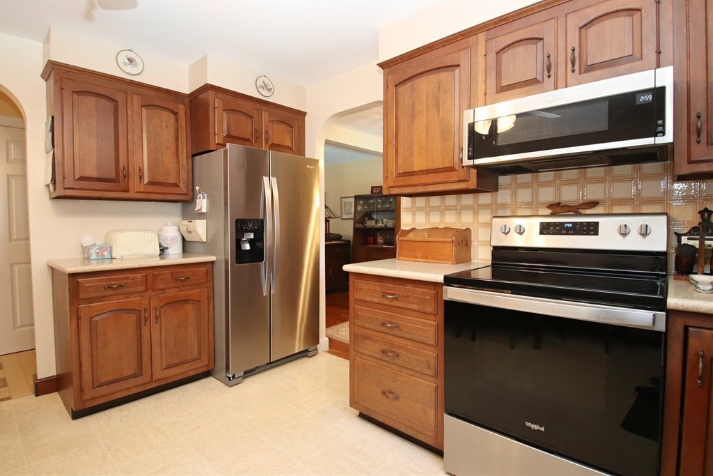 34 Adams Avenue Saugus, MA 01906 - Photo 6 of 42 a kitchen with stainless steel appliances granite countertop a stove microwave and refrigerator