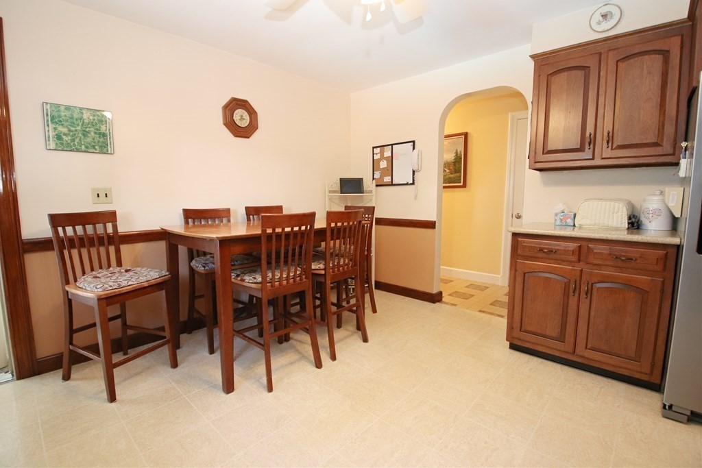 34 Adams Avenue Saugus, MA 01906 - Photo 7 of 42 a view of kitchen with granite countertop dining table chairs cabinets and stainless steel appliances