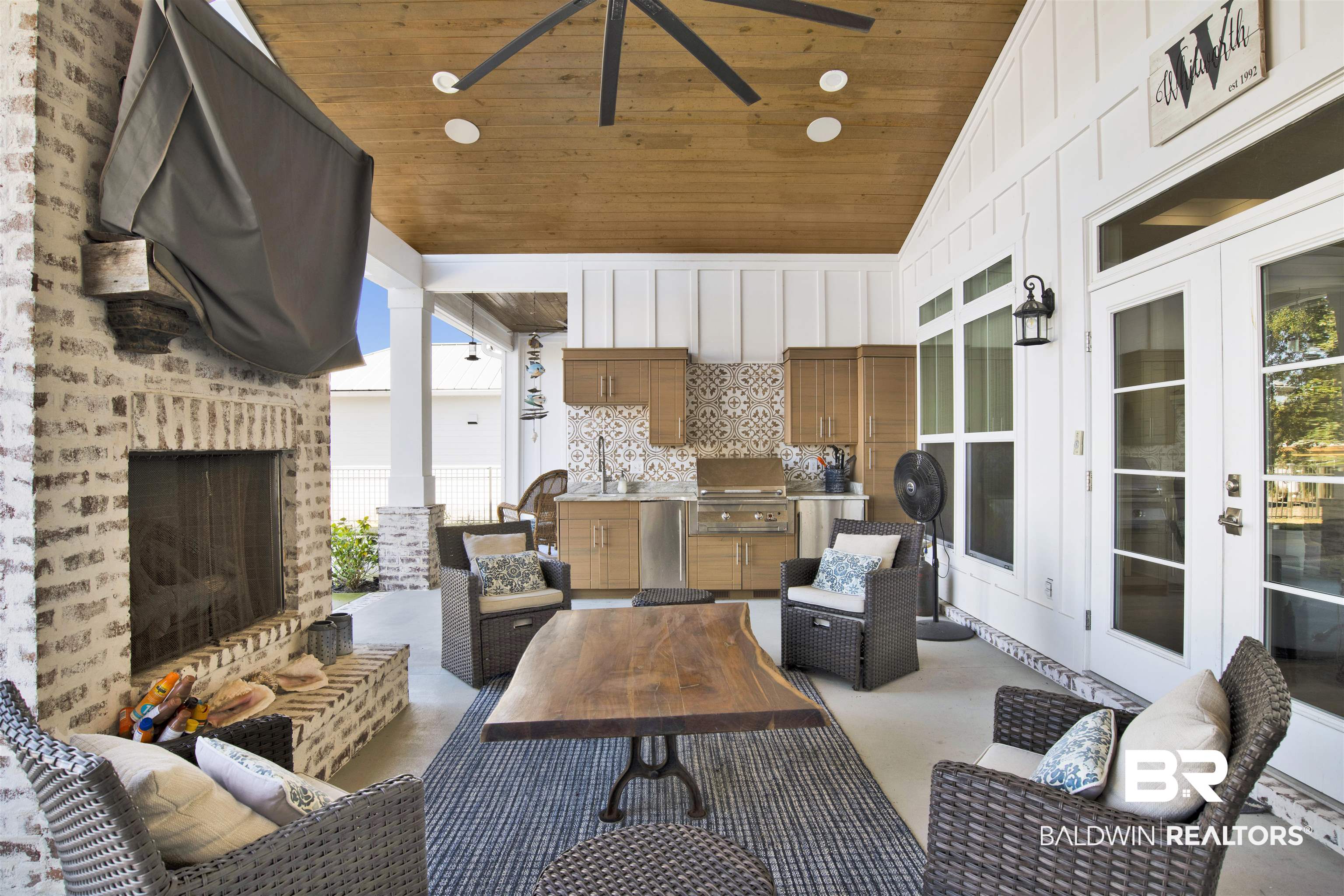 32937 River Road Orange Beach, AL 36561 - Photo 30 of 42 View of patio featuring ceiling fan, sink, exterior kitchen, a grill, and an outdoor brick fireplace