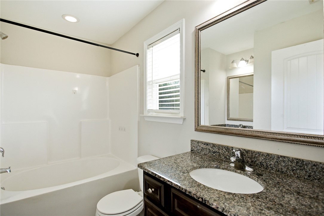 245 Maple Grove Road Seneca, SC 29678 - Photo 22 of 40 This bathroom features a sleek vanity and a tub with a convenient shower.