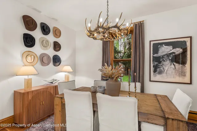 a view of a dining room with furniture and chandelier