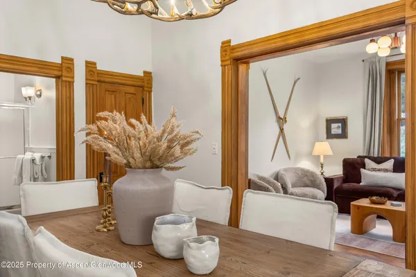 a kitchen with stainless steel appliances granite countertop a stove a sink a dining table and chairs