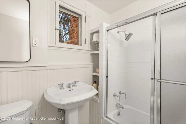 a bedroom with bed and a large window