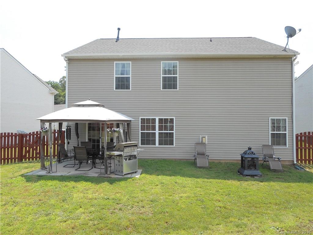 2987 Arthur Road, Unit 173 Indian Land, SC 29707 - Photo 2 of 18 a backyard of a house with yard table and chairs