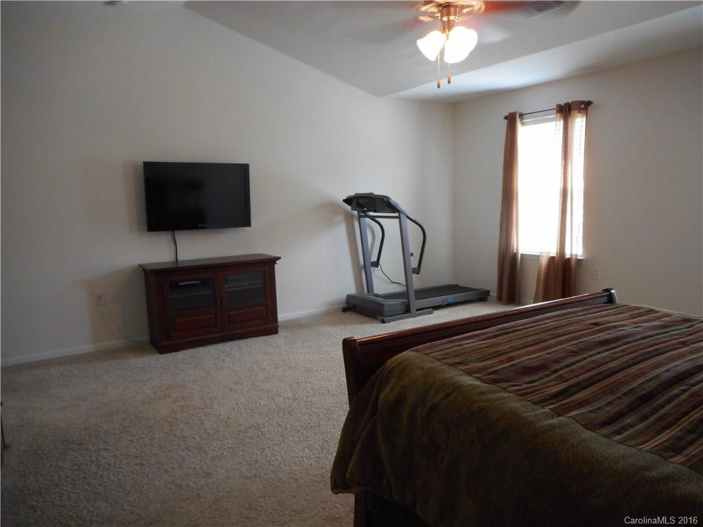 2987 Arthur Road, Unit 173 Indian Land, SC 29707 - Photo 11 of 18 a bedroom with a bed and a flat screen tv