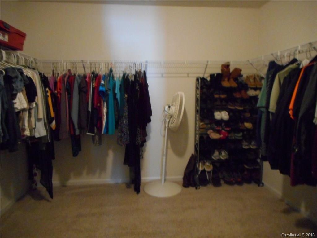 2987 Arthur Road, Unit 173 Indian Land, SC 29707 - Photo 13 of 18 a view of walk in closet with clothes and shoes