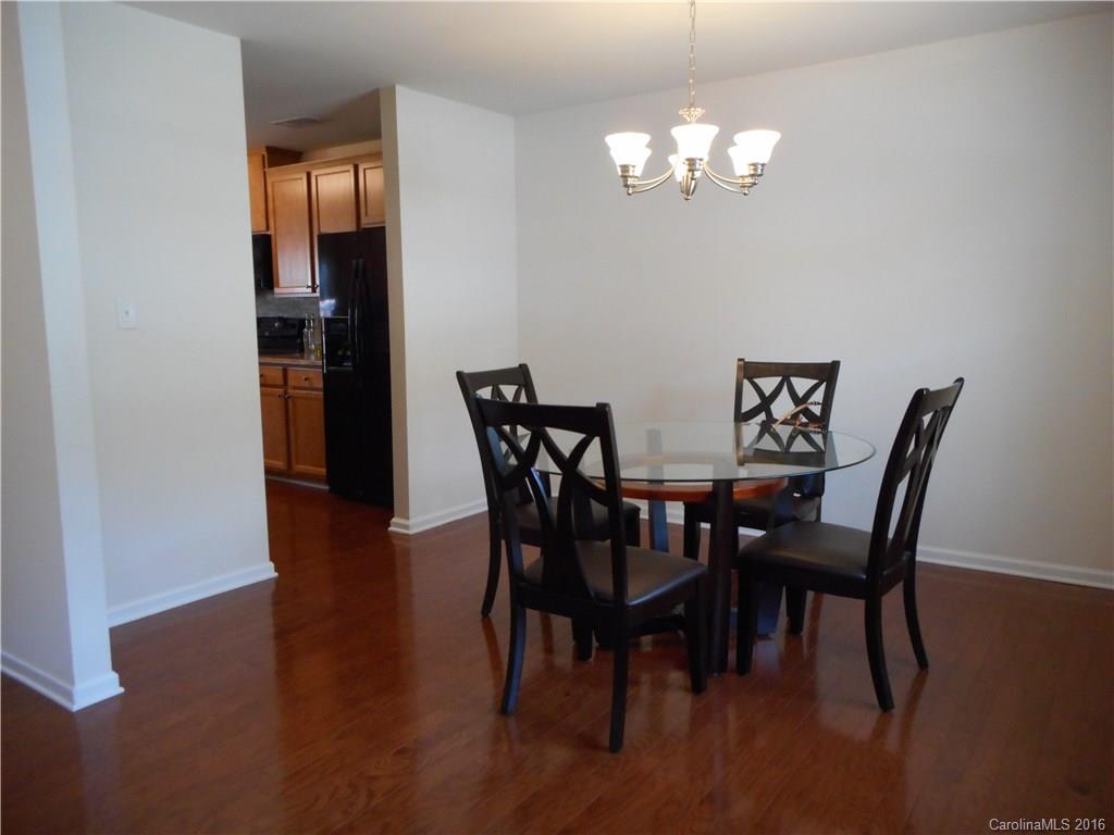 2987 Arthur Road, Unit 173 Indian Land, SC 29707 - Photo 4 of 18 a view of a dining room with furniture and wooden floor