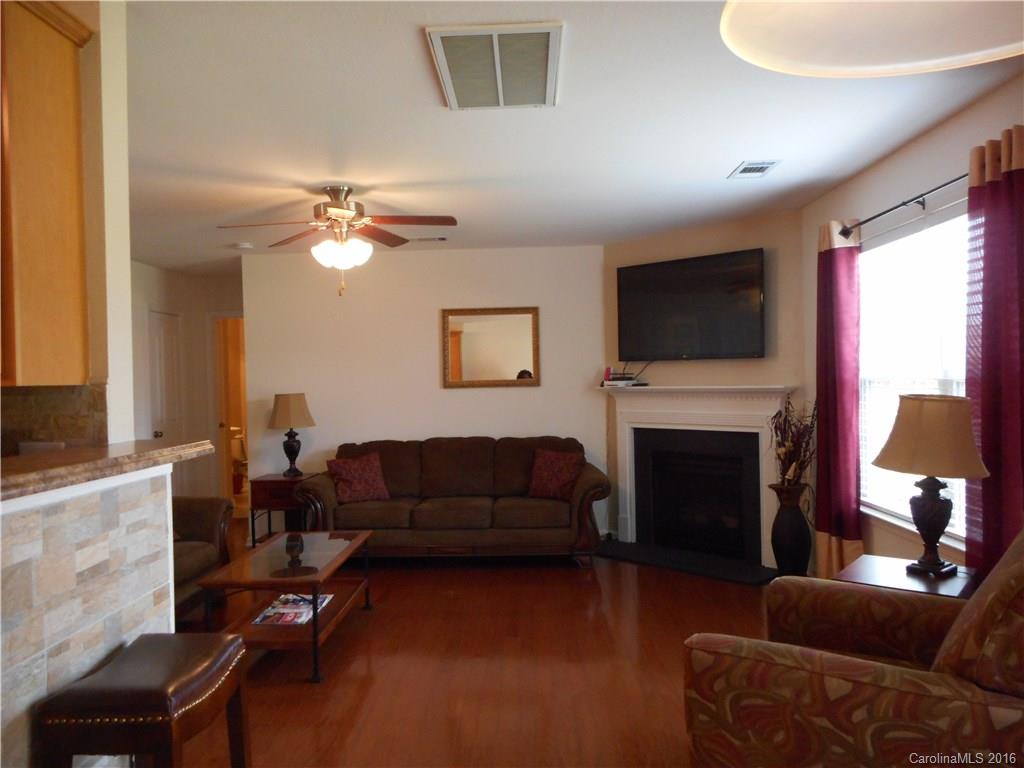 2987 Arthur Road, Unit 173 Indian Land, SC 29707 - Photo 6 of 18 a living room with furniture a fireplace and a flat screen tv