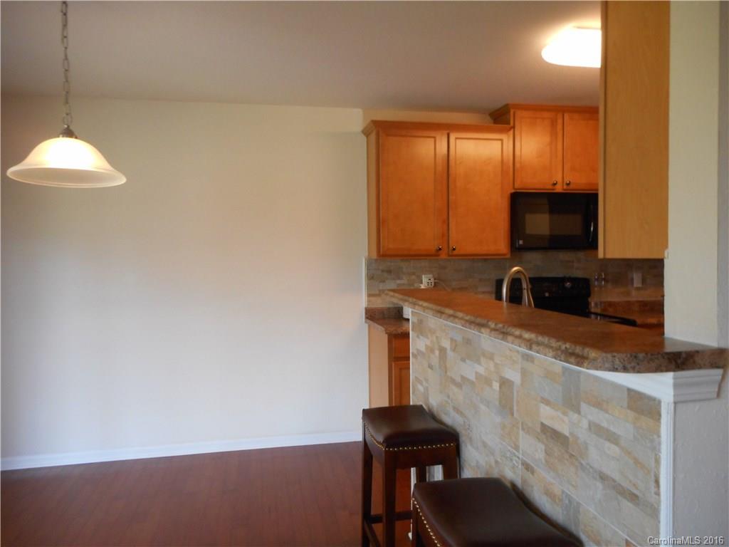 2987 Arthur Road, Unit 173 Indian Land, SC 29707 - Photo 9 of 18 a kitchen with a refrigerator and a stove top oven